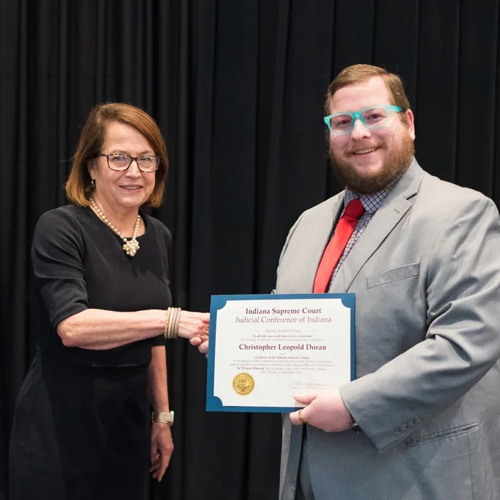 Christopher L. Doran receiving a certificate at an Indiana Judicial College conference